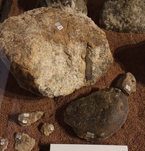 Hammer stone with six broken fragments used to break mastodon bones.