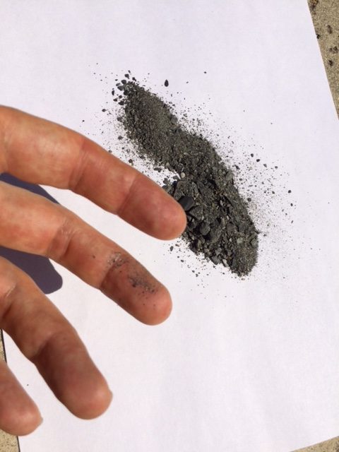 Bluff Creek soil sample with dust on finger